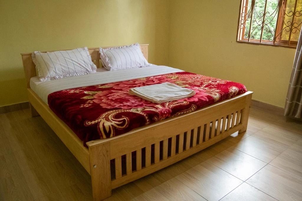 Ntebeko Homestay cozy room with wooden bed
